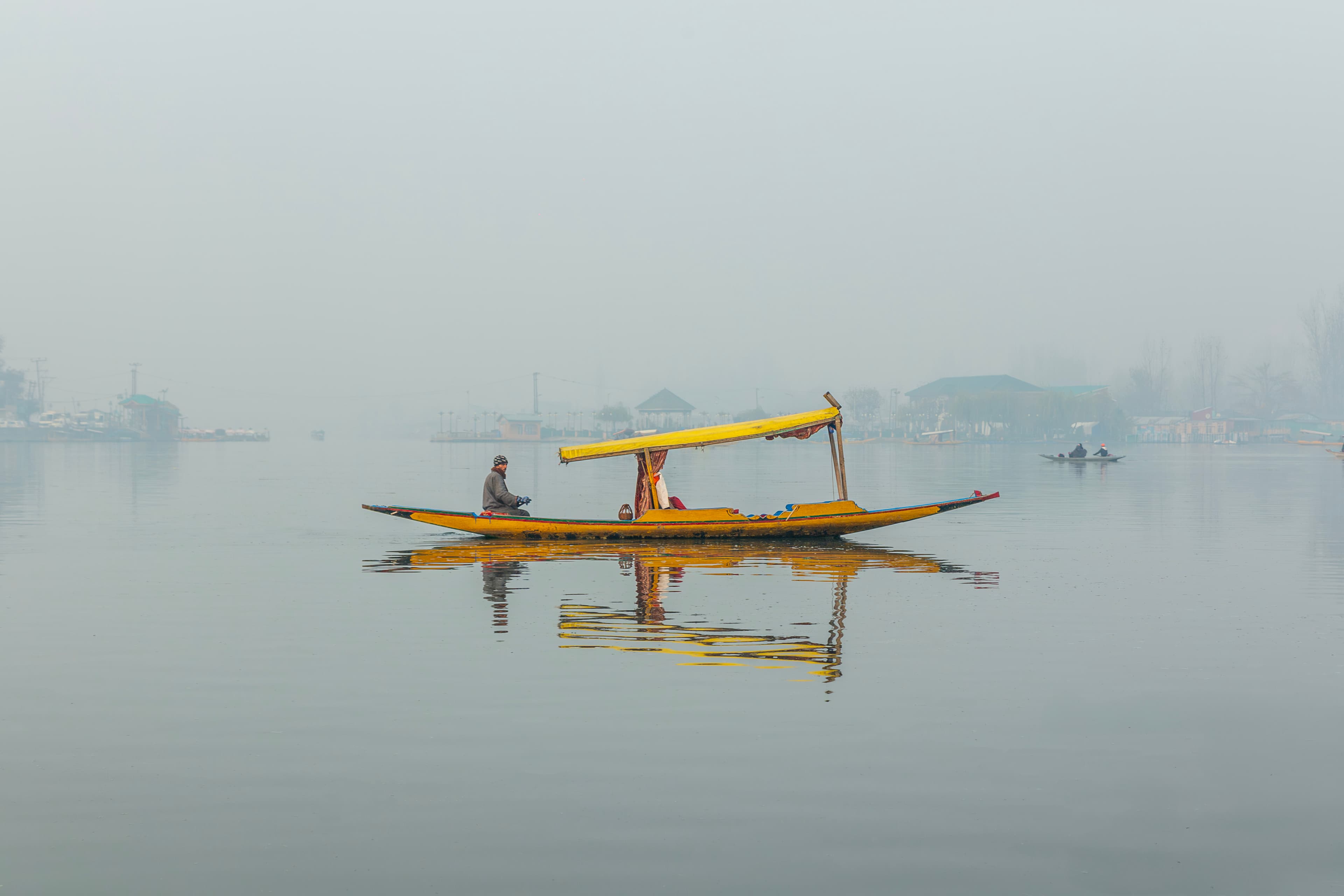 Yellow Shikara on Calm Dal Waters